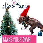 Pin: Advent craft for dino fans: make your own dinosaur Advent wreath - with image of a gold-painted T-Rex in a Santa hat trying to decorate a small Christmas tree