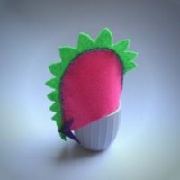 Stegosaurus egg cosy: how to DIY your own felt dinosaur egg cosy, with egg cosy over an egg and an egg cup