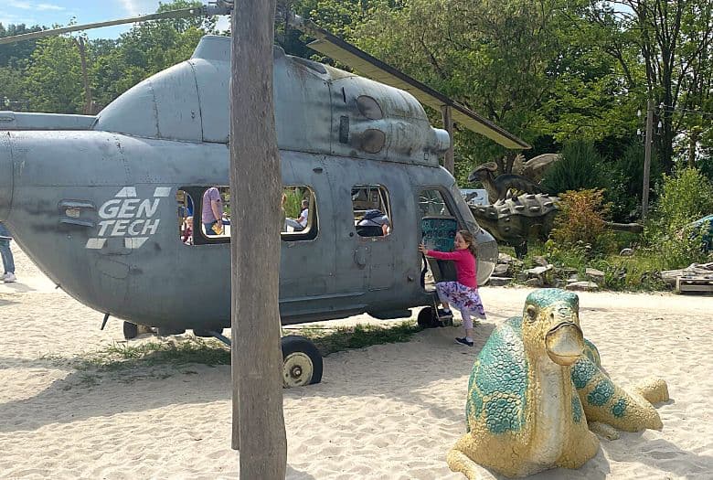 Our LDA with a helicoptor, with dinosaur (perhaps a Maiasaura?) in part of the playground at Dinoland Zwolle